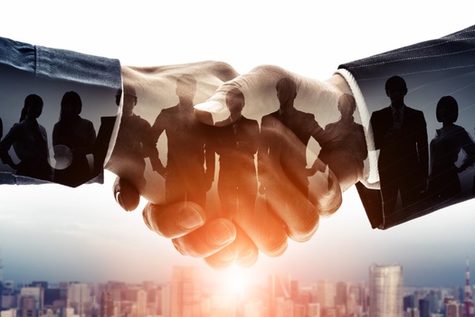 Shaking and holding hands with business partners