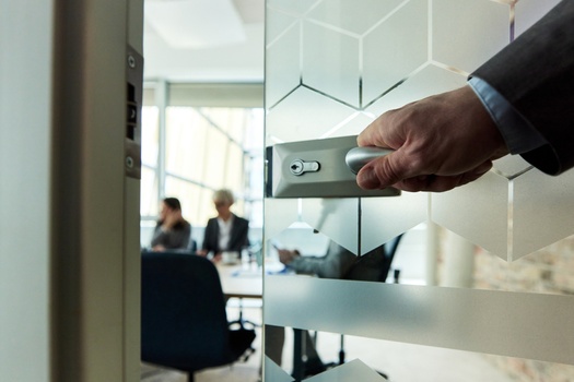 Man opening a office door